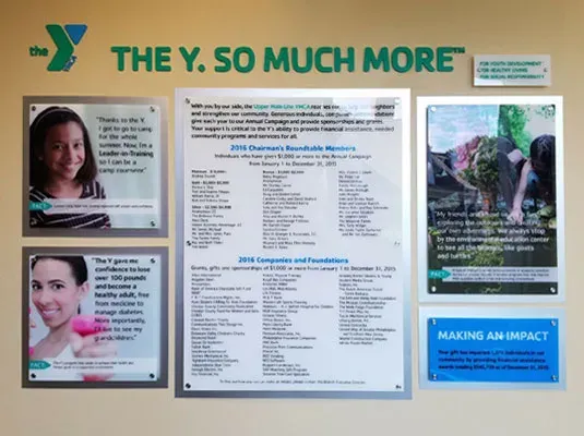 A donor wall using B&D's Acetek system — donor names inscribed on clear acetate set behind acrylic panels over a wall mural.