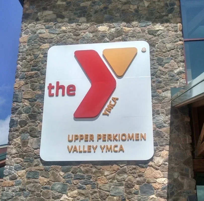 A B&D custom signage installation with dimensional lettering and a branded graphic.