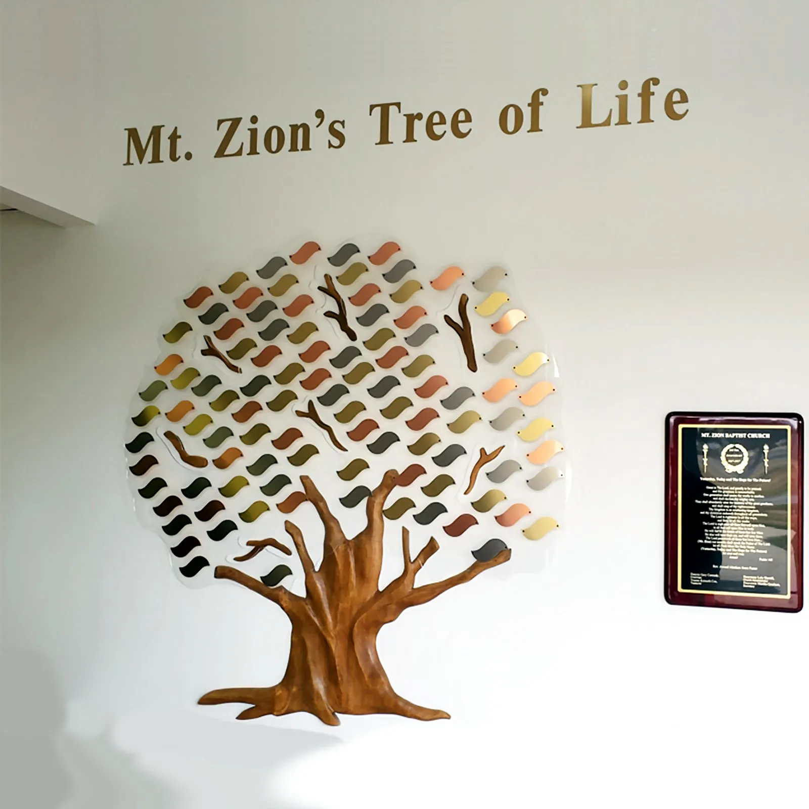 Mt. Zion's Tree of Life — a colorful metal-leaf donor tree with a carved wood trunk, for Mt. Zion Baptist Church.