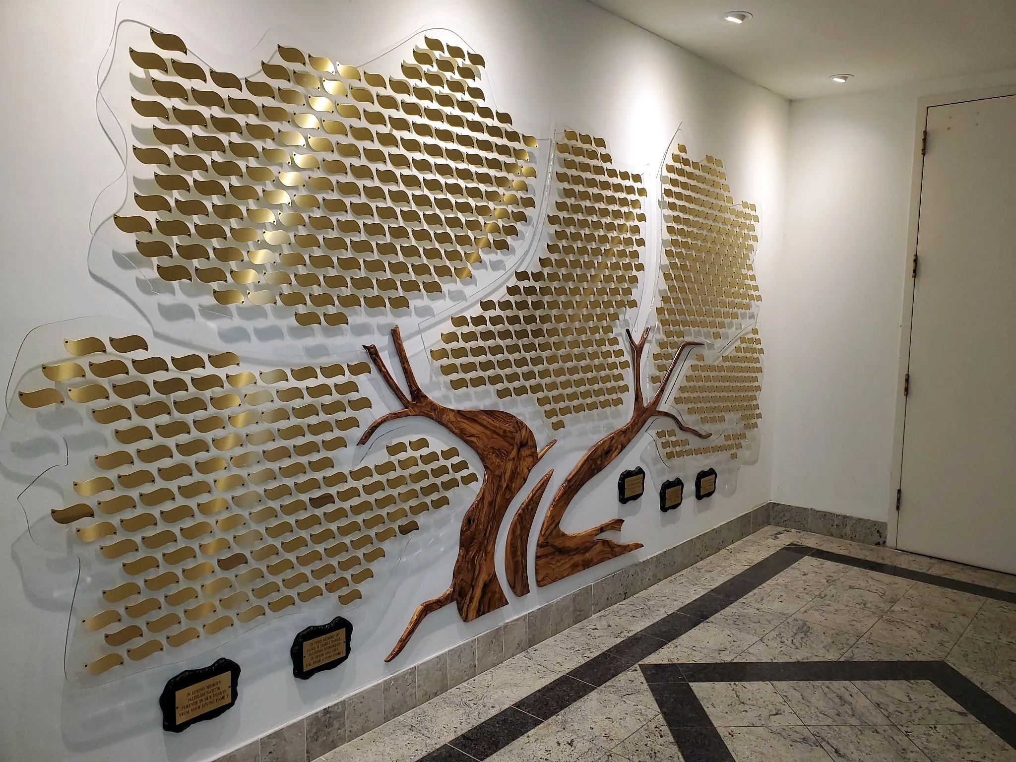 A B&D fully custom donor tree with gold engraved leaves and a hand-carved olive-wood trunk.