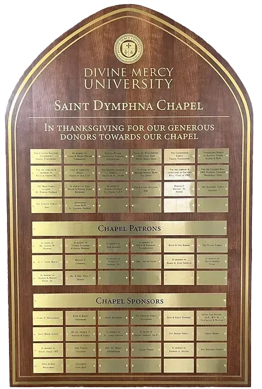A B&D engraved donor recognition plaque for Divine Mercy, with a decorative border and columns of donor names.