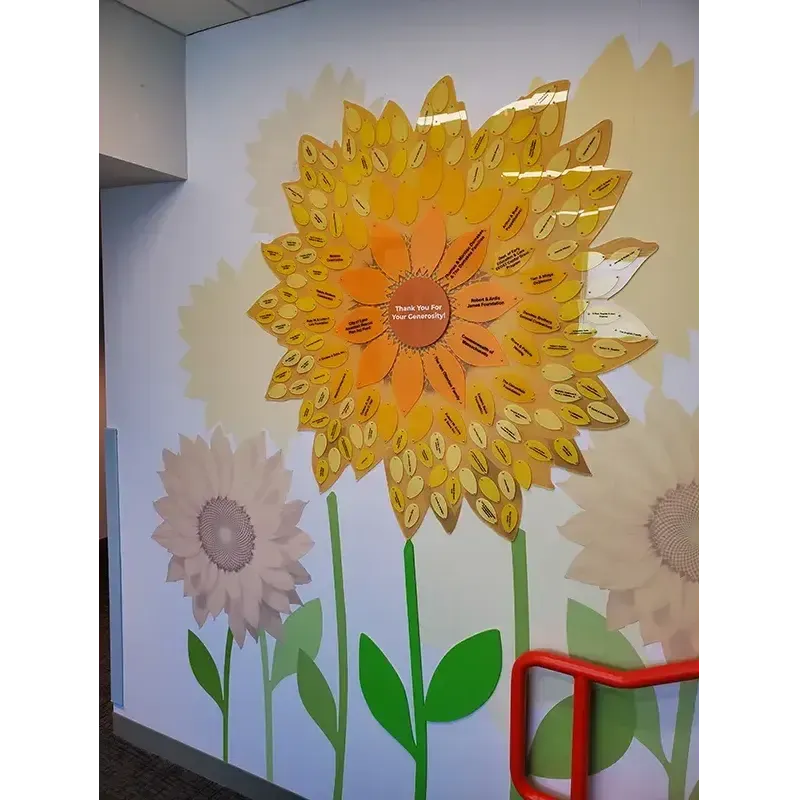 A B&D Donor Recognition Flower — a modular donor display with individual engraved petals radiating from a central campaign element.