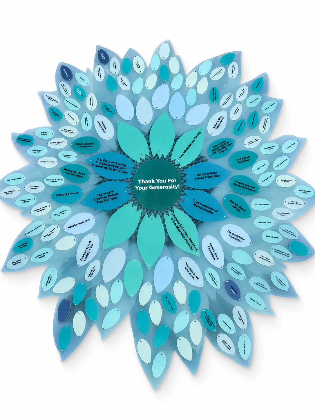 A B&D donor recognition flower in a teal and aqua palette, with engraved donor petals.