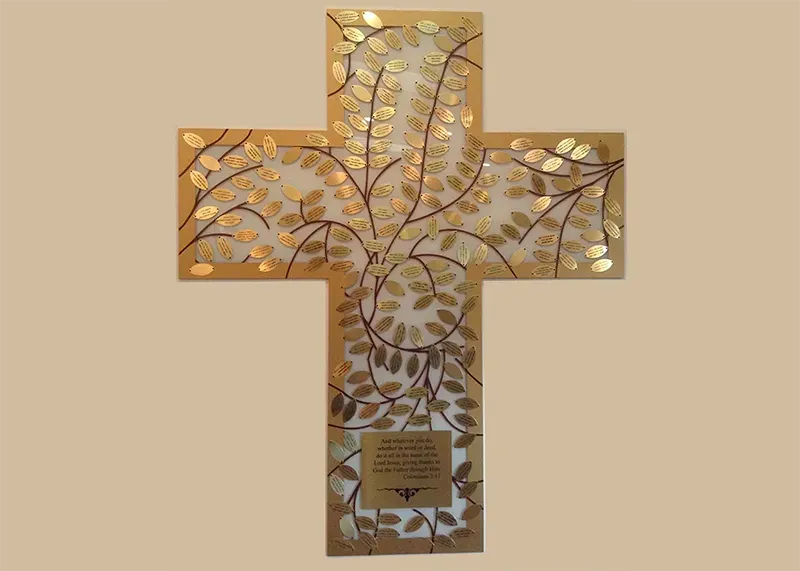 Donor recognition cross at the Newman Center, with engraved donor name plates arranged around a faith-inspired cross design.