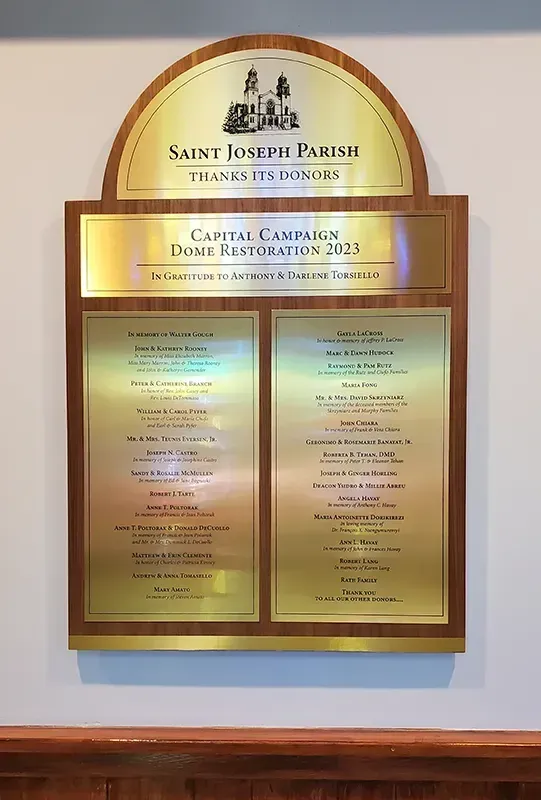 A B&D custom bronze donor recognition plaque installed for Saint Joseph's, with engraved donor names beneath a dedication header.