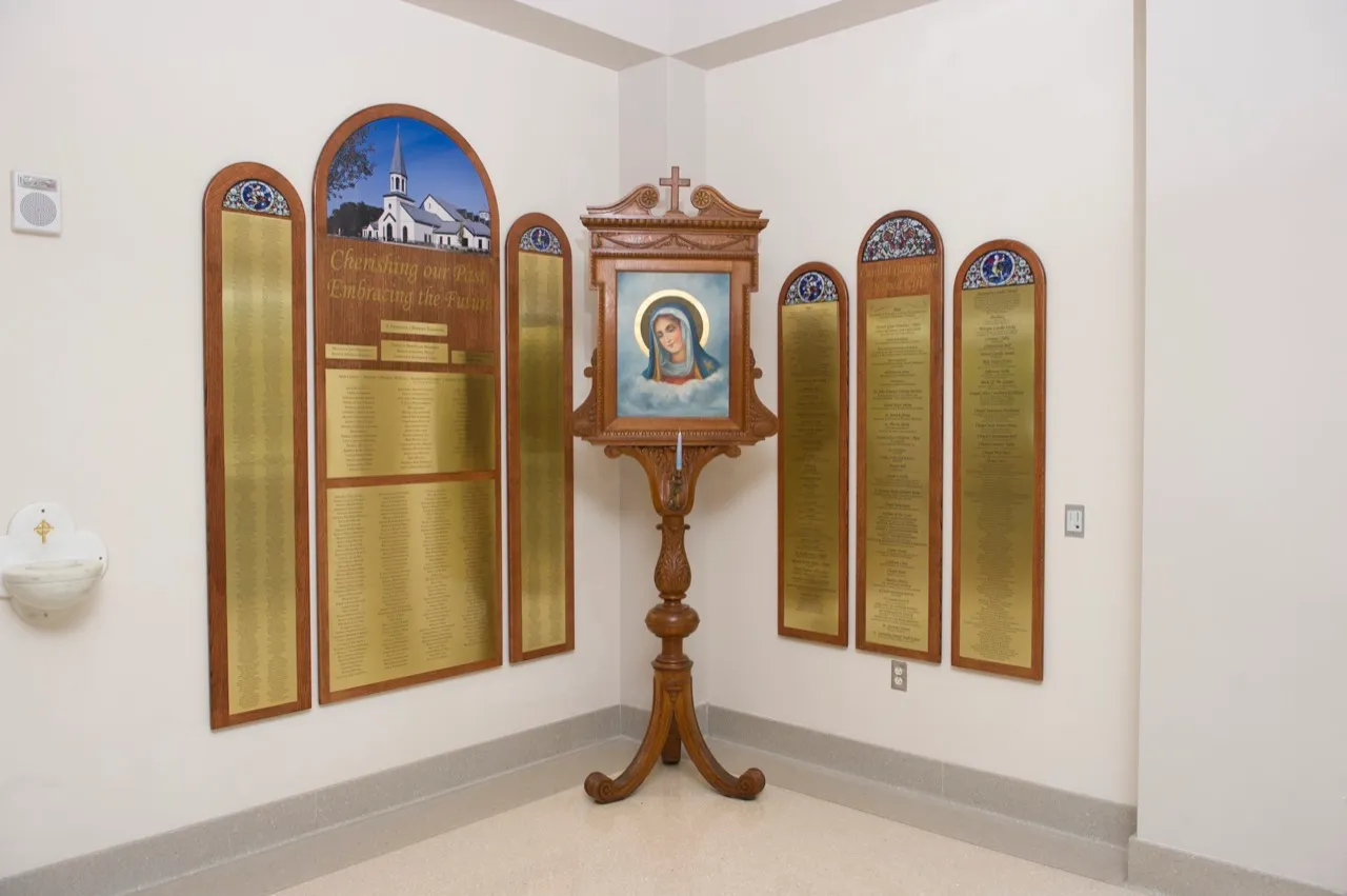 Expandable donor recognition wall at St. Joseph, with individual donor name plates mounted across a bright gathering space.