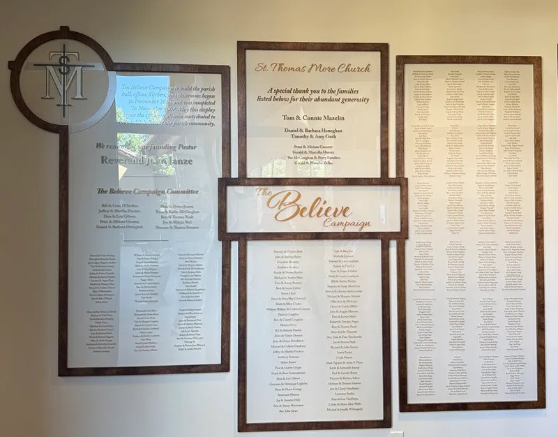 Donor recognition wall at St. Thomas, featuring engraved donor name plates mounted in a gathering space.