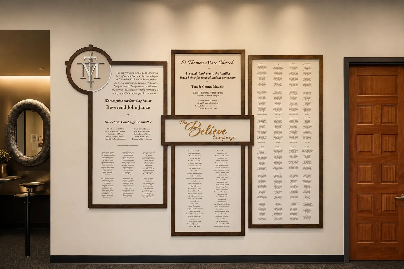 B&D donor recognition wall for St. Thomas More Church's Believe Campaign — framed engraved name panels flanking a central “Believe” sign.