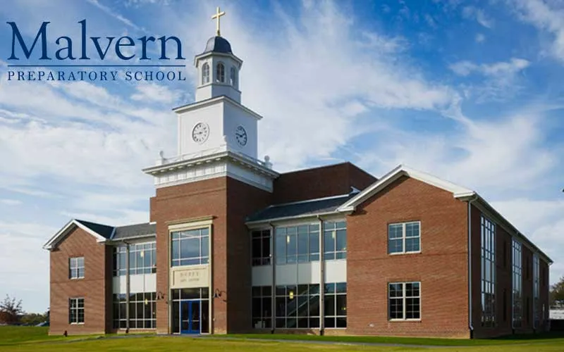 A B&D wall of honor at Malvern Preparatory School — layered engraved plaques arranged around the school seal.